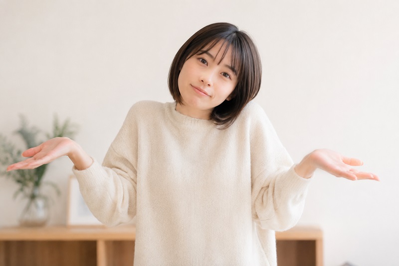 「しょうがないね」のポーズをしている女性